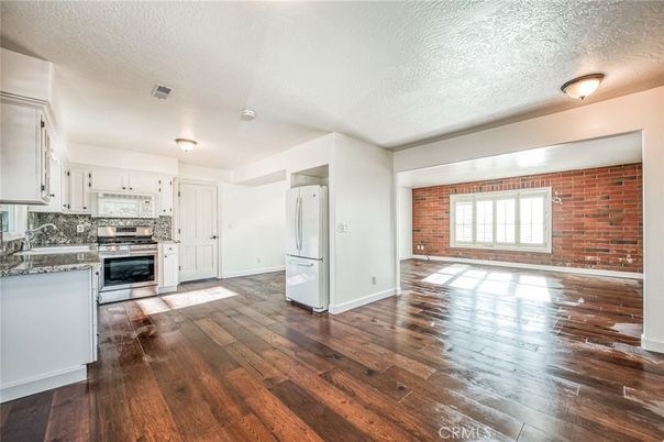 Empty room, Interior, Kitchen, Stainless Steel Appliances, Stone Walls, Wood Texture Flooring