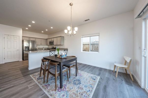 Chandelier, Dining room, Interior, Kitchen, Pendant Lights, Recessed Lighting, Stainless Steel Appliances, Wood Texture Flooring