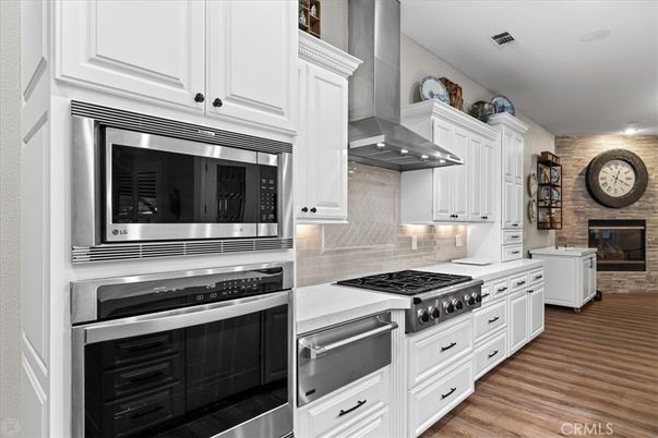 Fireplace, Interior, Kitchen, Stainless Steel Appliances, Stone Walls, Wood Texture Flooring