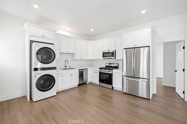 Interior, Kitchen, Recessed Lighting, Stainless Steel Appliances, Washer, Wood Texture Flooring