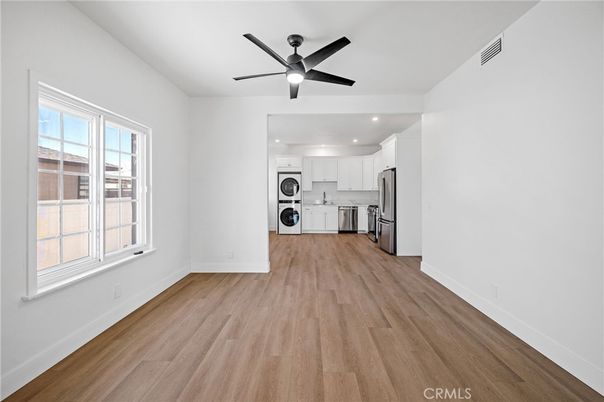 Empty room, Interior, Kitchen, Recessed Lighting, Stainless Steel Appliances, Wood Texture Flooring