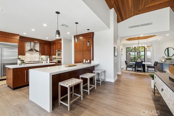 Chandelier, Dining room, Interior, Kitchen, Pendant Lights, Recessed Lighting, Stainless Steel Appliances, Wooden Ceilings, Wood Texture Flooring