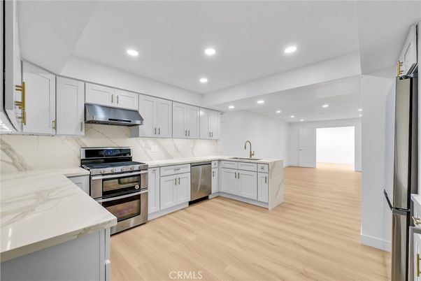 Interior, Kitchen, Marble Walls, Recessed Lighting, Stainless Steel Appliances, Wood Texture Flooring