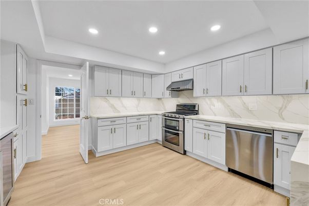 Interior, Kitchen, Marble Walls, Recessed Lighting, Stainless Steel Appliances, Wood Texture Flooring