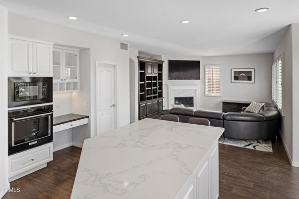 Fireplace, Interior, Kitchen, Living room, Recessed Lighting, Stainless Steel Appliances, Wood Texture Flooring