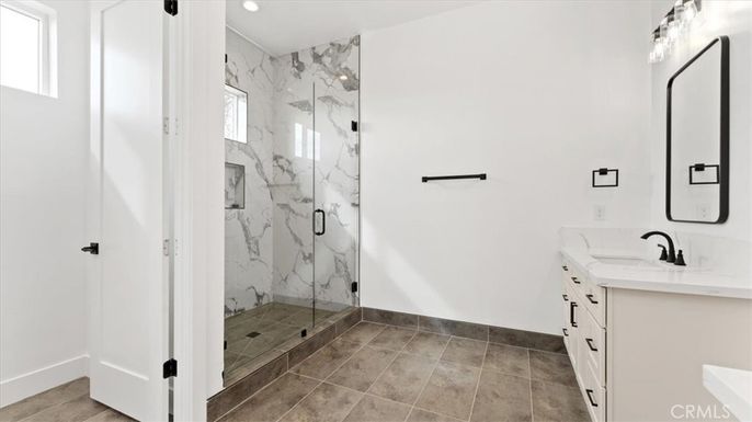 Bathroom, Dual Sink Vanities, Glass Shower, Interior, Marble Walls, Recessed Lighting