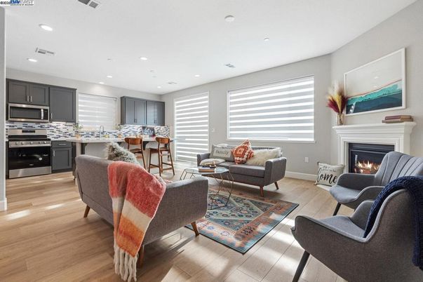 Fireplace, Interior, Kitchen, Living room, Recessed Lighting, Stainless Steel Appliances, Wood Texture Flooring