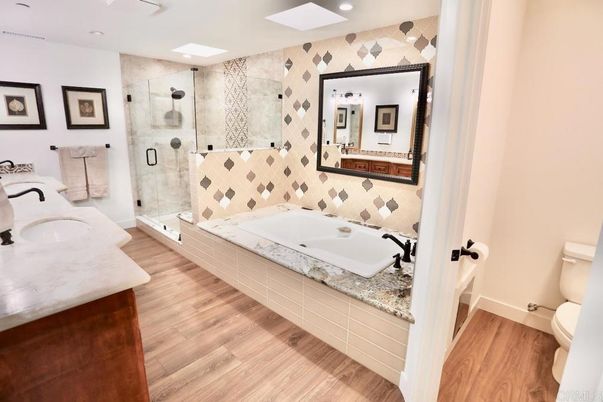 Bathroom, Dual Sink Vanities, Glass Shower, Interior, Recessed Lighting, Wood Texture Flooring