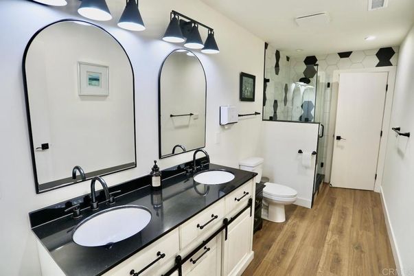 Bathroom, Dual Sink Vanities, Glass Shower, Interior, Recessed Lighting, Wood Texture Flooring