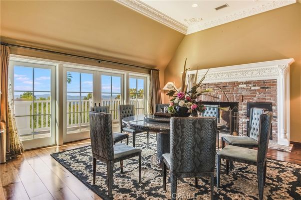 Dining room, Fireplace, Interior, Recessed Lighting, Stone Walls, Water, Wood Texture Flooring