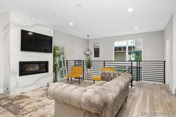 Fireplace, Interior, Living room, Marble Walls, Pendant Lights, Recessed Lighting, Wood Texture Flooring