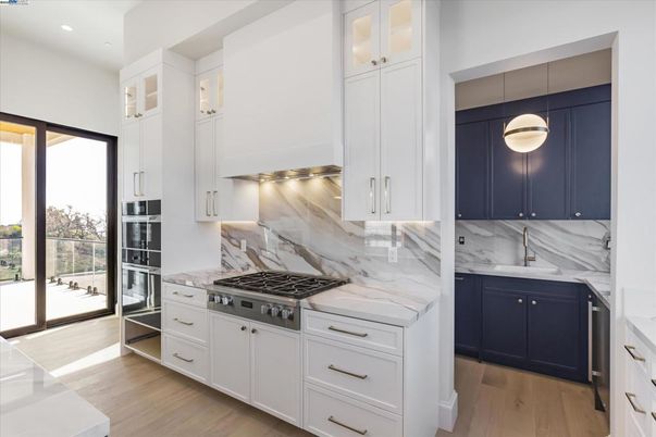 Interior, Kitchen, Marble Walls, Pendant Lights, Recessed Lighting, Stainless Steel Appliances, Wood Texture Flooring