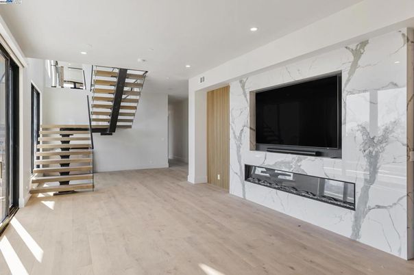 Fireplace, Interior, Marble Walls, Recessed Lighting, Wood Texture Flooring