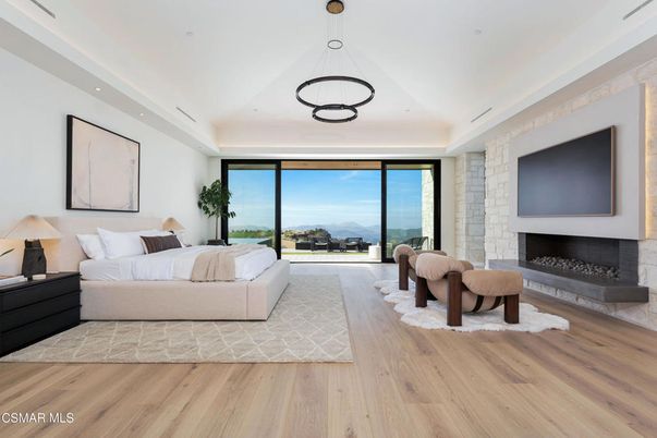 Bedroom, Fireplace, Interior, Pendant Lights, Recessed Lighting, Water, Wood Texture Flooring