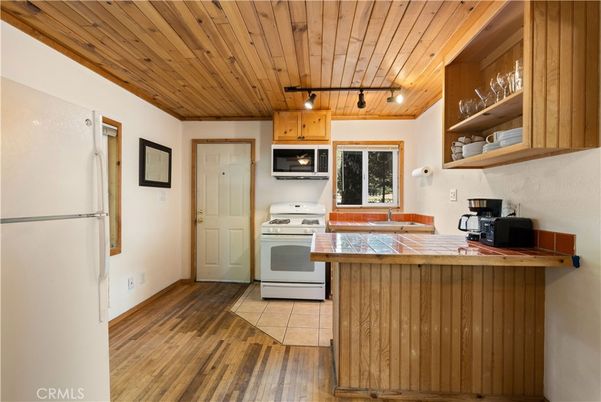 Interior, Kitchen, Tile Countertops, Wooden Ceilings, Wood Texture Flooring
