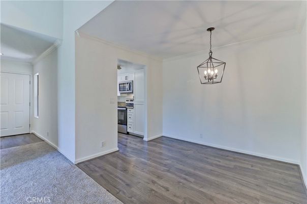 Empty room, Interior, Kitchen, Pendant Lights, Stainless Steel Appliances, Wood Texture Flooring