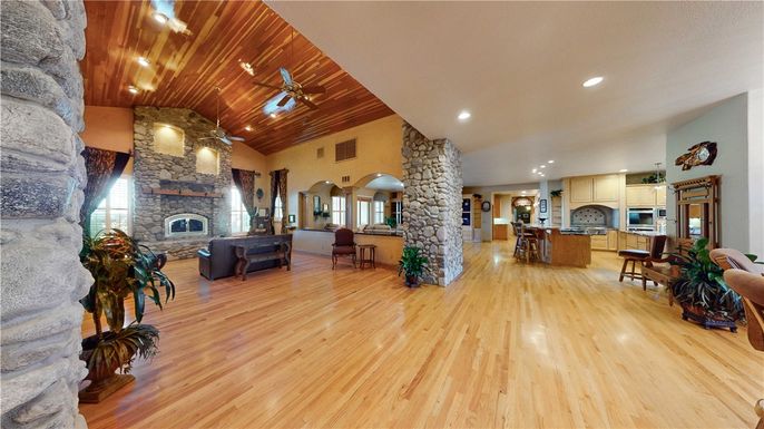Dining room, Fireplace, Interior, Kitchen, Living room, Recessed Lighting, Stainless Steel Appliances, Stone Walls, Wooden Ceilings, Wood Texture Flooring