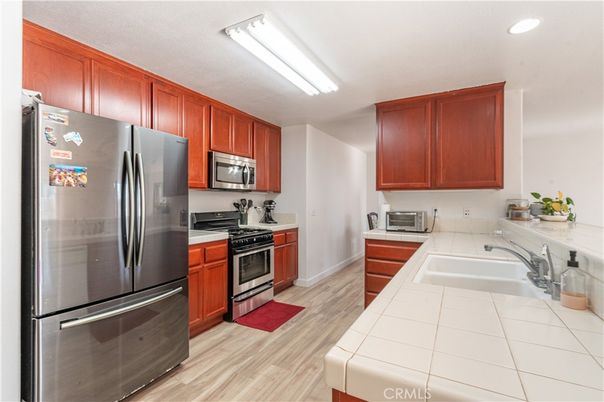 Interior, Kitchen, Recessed Lighting, Stainless Steel Appliances, Tile Countertops, Wood Texture Flooring