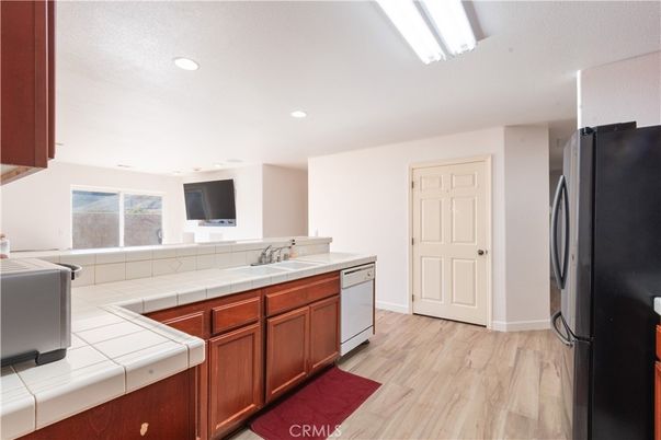 Interior, Kitchen, Recessed Lighting, Tile Countertops, Wood Texture Flooring