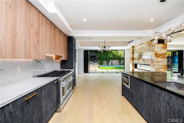 Chandelier, Interior, Kitchen, Marble Walls, Pendant Lights, Recessed Lighting, Stainless Steel Appliances, Wood Texture Flooring