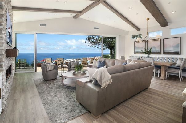 Dining room, Fireplace, Interior, Living room, Pendant Lights, Recessed Lighting, Stone Walls, Water, Wooden Beams, Wood Texture Flooring