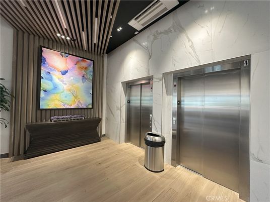 Elevator, Interior, Marble Walls, Recessed Lighting, Wood Texture Flooring