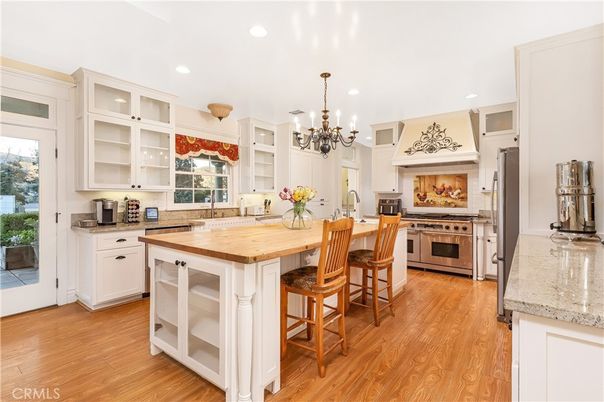 Chandelier, Fireplace, Interior, Kitchen, Recessed Lighting, Stainless Steel Appliances, Wood Texture Flooring