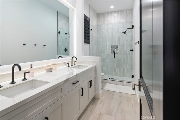 Bathroom, Dual Sink Vanities, Glass Shower, Interior, Recessed Lighting, Wood Texture Flooring