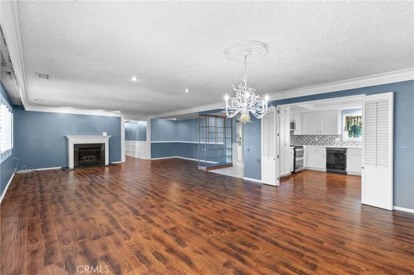 Chandelier, Empty room, Fireplace, Interior, Kitchen, Recessed Lighting, Wood Texture Flooring