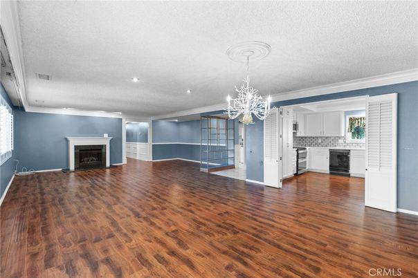 Chandelier, Empty room, Fireplace, Interior, Kitchen, Recessed Lighting, Wood Texture Flooring