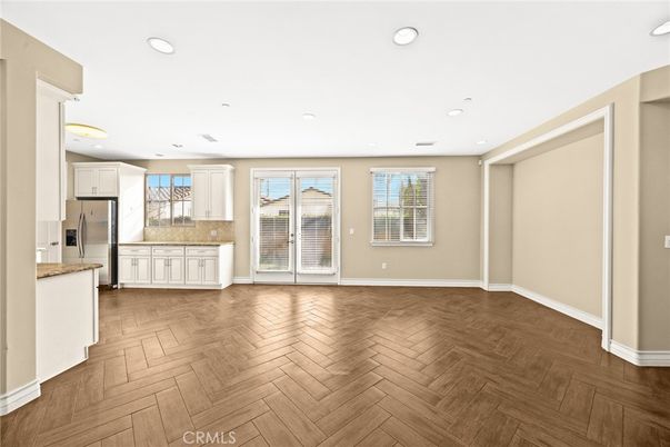 Empty room, Interior, Kitchen, Recessed Lighting, Stainless Steel Appliances, Wood Texture Flooring