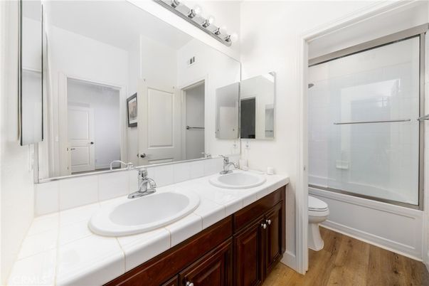 Bathroom, Dual Sink Vanities, Glass Shower, Interior, Tile Countertops, Wood Texture Flooring