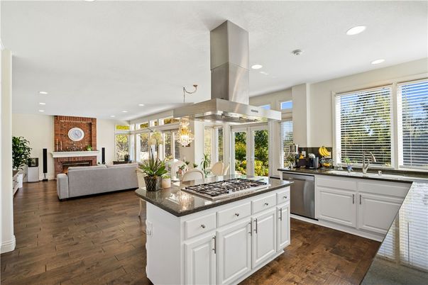 Chandelier, Dining room, Fireplace, Interior, Kitchen, Living room, Recessed Lighting, Stainless Steel Appliances, Wood Texture Flooring