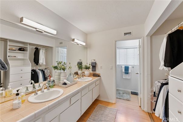 Bathroom, Dual Sink Vanities, Glass Shower, Interior, Tile Countertops, Walk-in Closets, Wood Texture Flooring