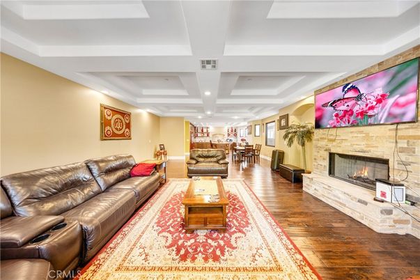 Dining room, Fireplace, Interior, Living room, Recessed Lighting, Stone Walls, Wood Texture Flooring