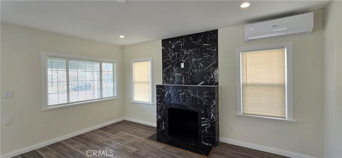Fireplace, Interior, Marble Walls, Recessed Lighting, Wood Texture Flooring