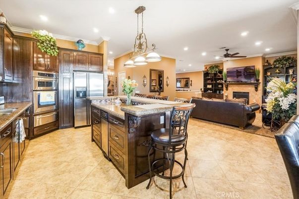 Chandelier, Dining room, Fireplace, Interior, Kitchen, Living room, Pendant Lights, Recessed Lighting, Stainless Steel Appliances