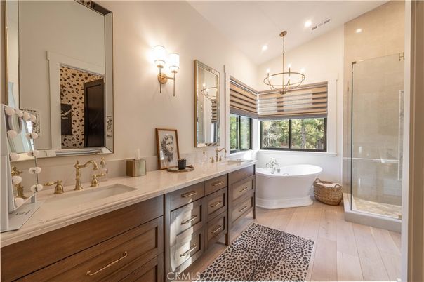 Bathroom, Chandelier, Dual Sink Vanities, Free Standing Baths, Glass Shower, Interior, Pendant Lights, Recessed Lighting, Wood Texture Flooring