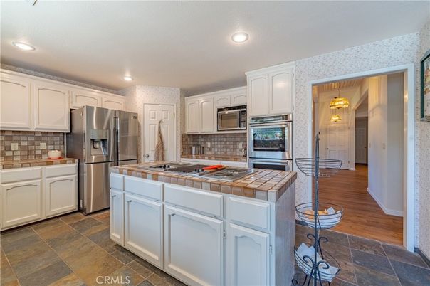 Interior, Kitchen, Recessed Lighting, Stainless Steel Appliances, Tile Countertops, Wood Texture Flooring