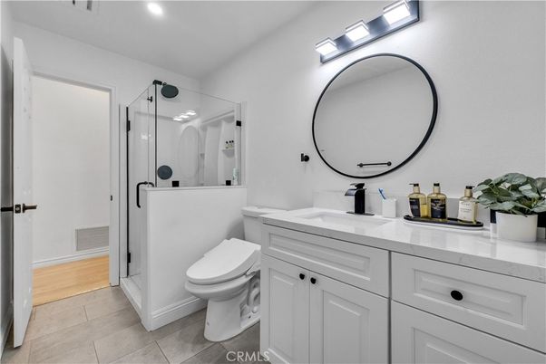 Bathroom, Dual Sink Vanities, Glass Shower, Interior, Recessed Lighting, Wood Texture Flooring