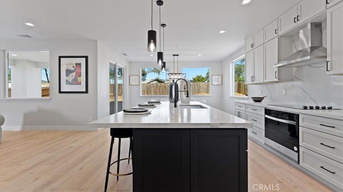 Interior, Kitchen, Marble Walls, Pendant Lights, Recessed Lighting, Stainless Steel Appliances, Wood Texture Flooring