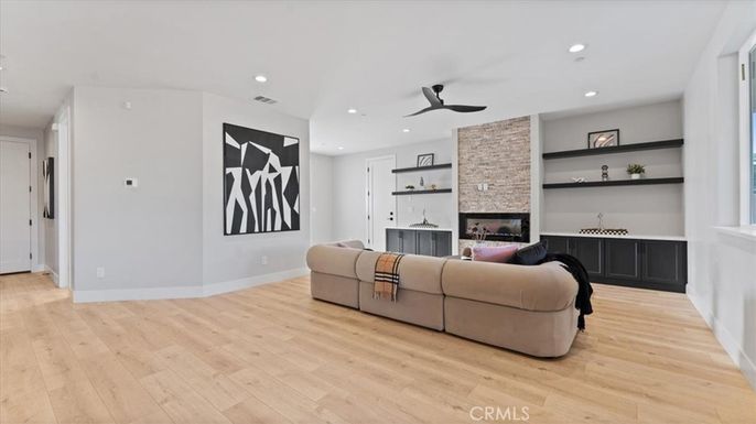 Fireplace, Interior, Living room, Recessed Lighting, Stone Walls, Wood Texture Flooring