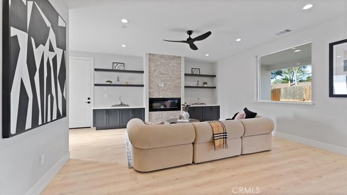 Fireplace, Interior, Living room, Recessed Lighting, Stone Walls, Wood Texture Flooring