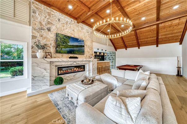 Billiard Table, Chandelier, Fireplace, Game Room, Interior, Living room, Pendant Lights, Recessed Lighting, Stone Walls, Wooden Beams, Wooden Ceilings, Wood Texture Flooring