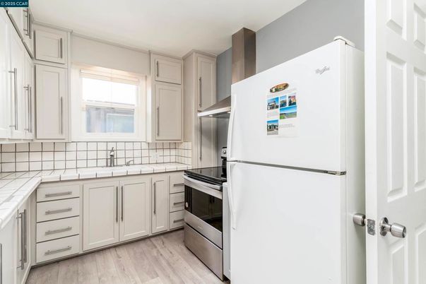 Interior, Kitchen, Stainless Steel Appliances, Tile Countertops, Wood Texture Flooring