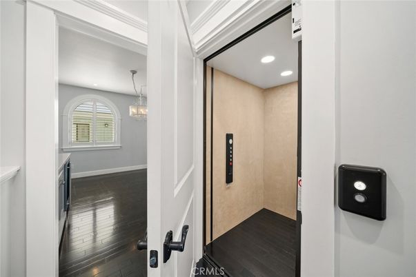 Chandelier, Elevator, Interior, Recessed Lighting, Wood Texture Flooring