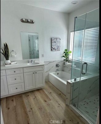 Bathroom, Dual Sink Vanities, Glass Shower, Interior, Marble Walls, Wood Texture Flooring