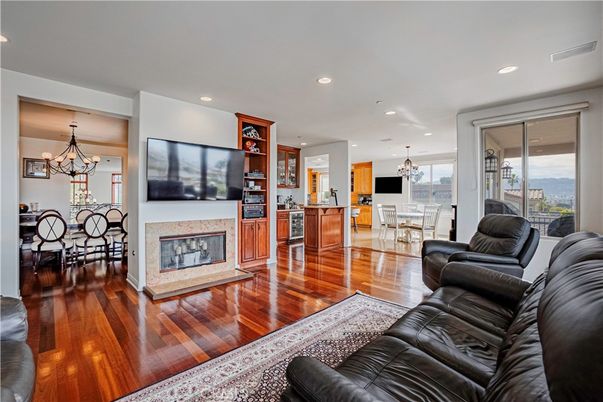 Chandelier, Dining room, Fireplace, Interior, Living room, Pendant Lights, Recessed Lighting, Wood Texture Flooring