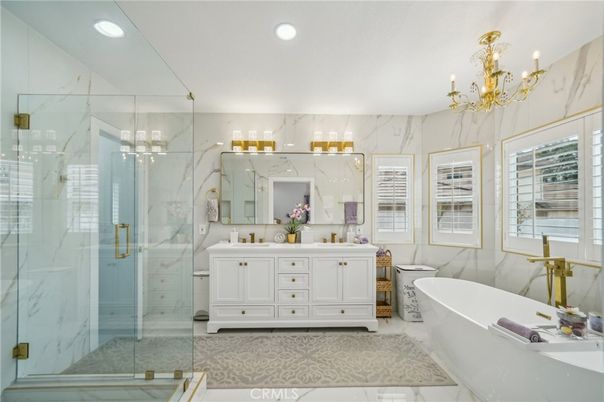 Bathroom, Chandelier, Dual Sink Vanities, Free Standing Baths, Glass Shower, Interior, Marble Walls, Recessed Lighting