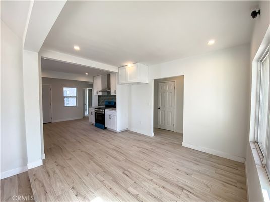 Empty room, Interior, Kitchen, Recessed Lighting, Stainless Steel Appliances, Wood Texture Flooring